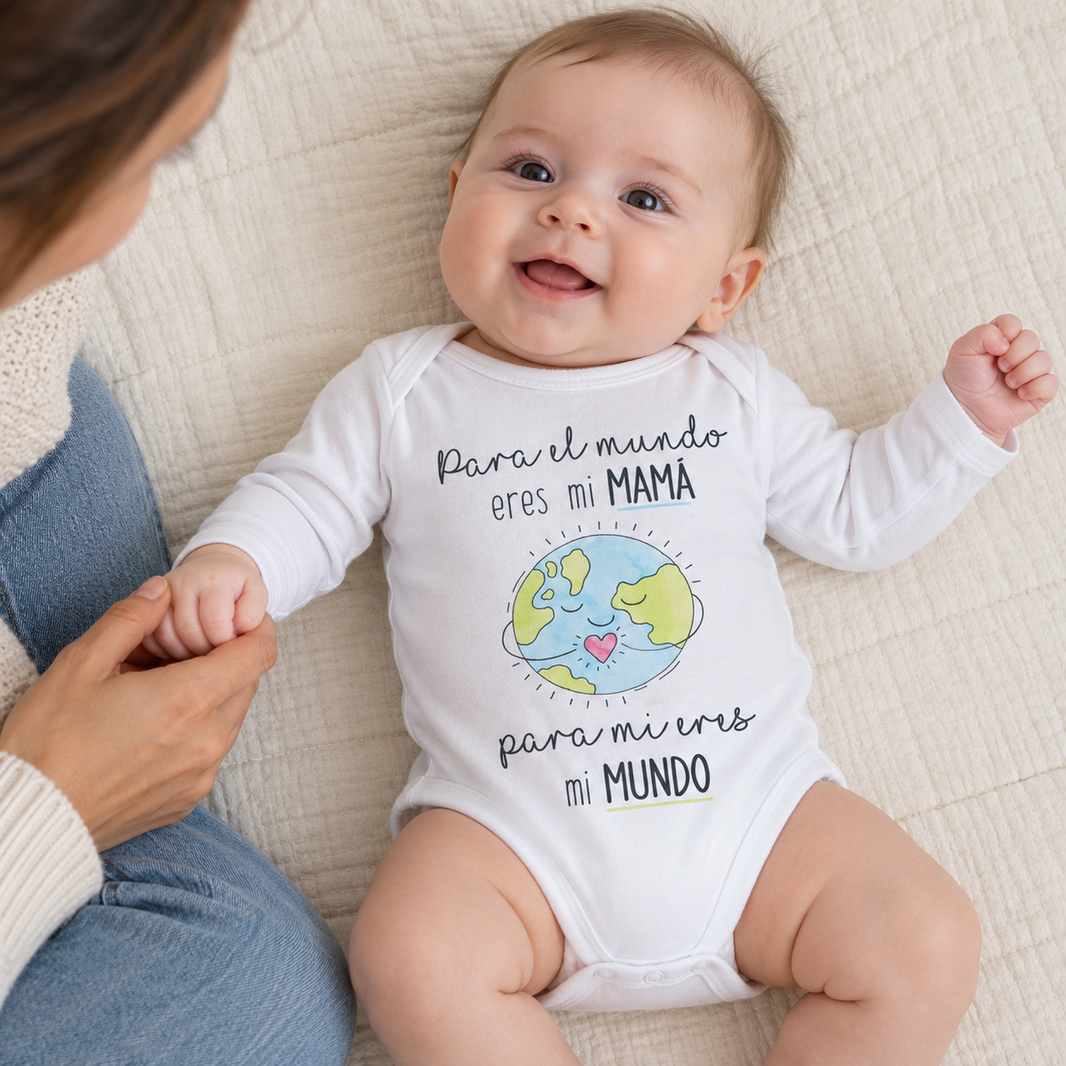 Bebé con el body Mamá Eres Mi Mundo sobre una manta junto a su madre