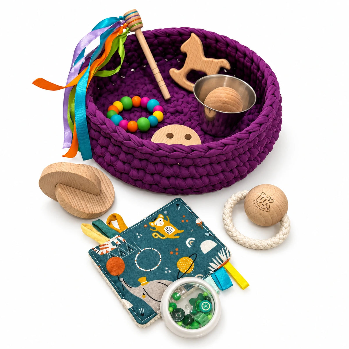 Cesto de los tesoros Velvet Plum de trapillo morado: detalle del cesto, el trapito y los accesorios sensoriales.