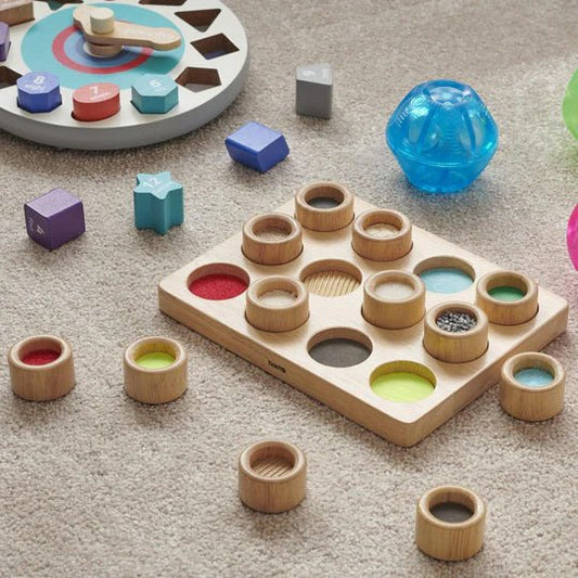 JUGUETE ESTIMULACIÓN SENSORIAL TICKIT ·TABLERO TOCA Y COMBINA· - Happy Moments Baby