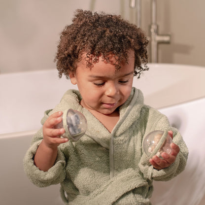 Niño observando las figuras del interior de las bolas de baño